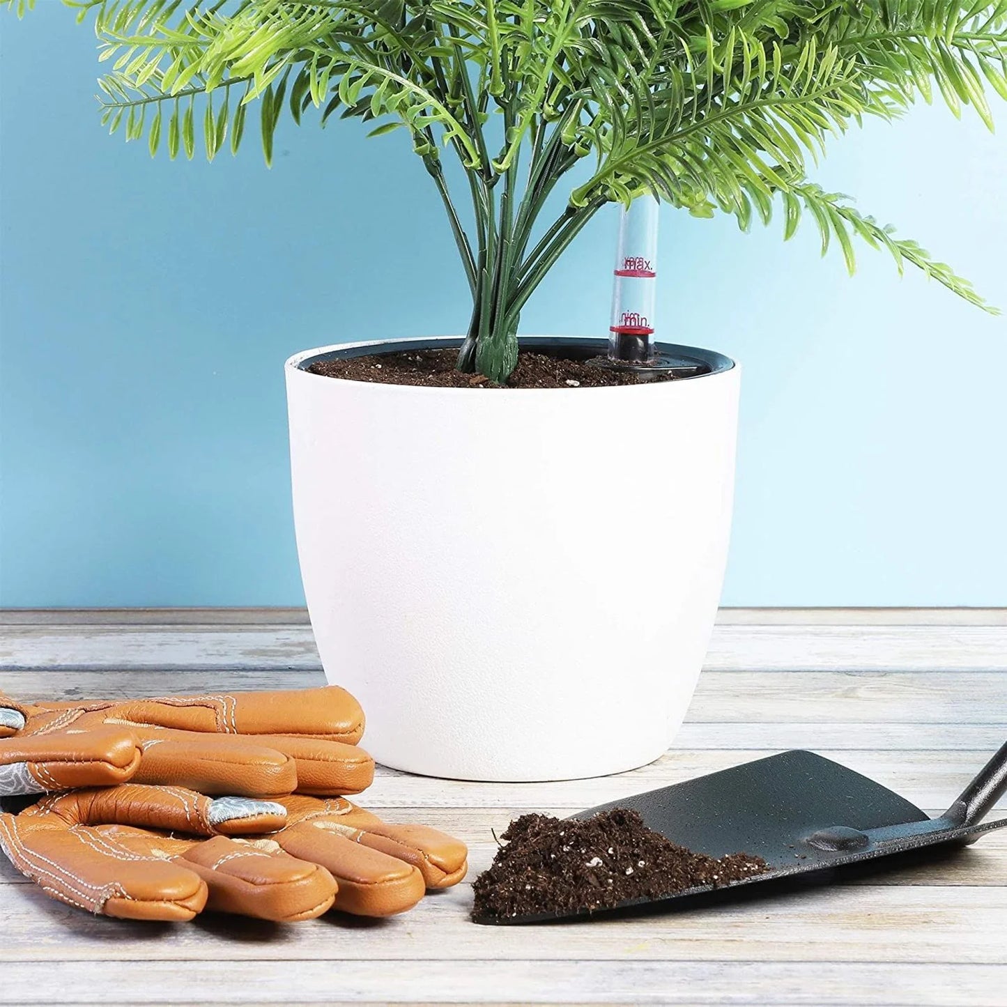 An image or diagram illustrating the two-part design of the planter with the white outer pot and black inner basket.