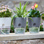 A diagram or photo illustrating the double-layer design of the self-watering planter, highlighting the water reservoir and inner liner with wick.