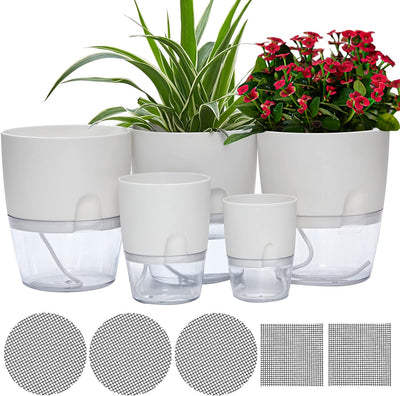 A group of five white self-watering planter pots in various sizes, suitable for indoor and outdoor plants, showcasing their modern design.